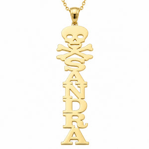 Close-up of a yellow gold vertical name pendant with custom block letters and a skull-and-crossbones design.