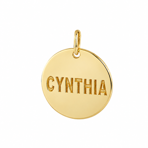 Close up of a solid yellow gold round disc charm pendant custom laser engraved with the name Cynthia.