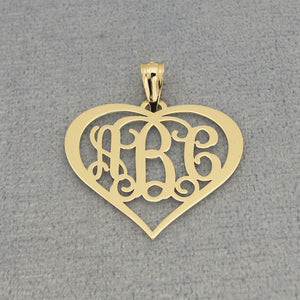 Close-up of custom laser-engraved three-initial solid gold heart monogram pendant