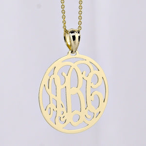 Three-initial solid gold circle monogram pendant necklace on a delicate gold chain.