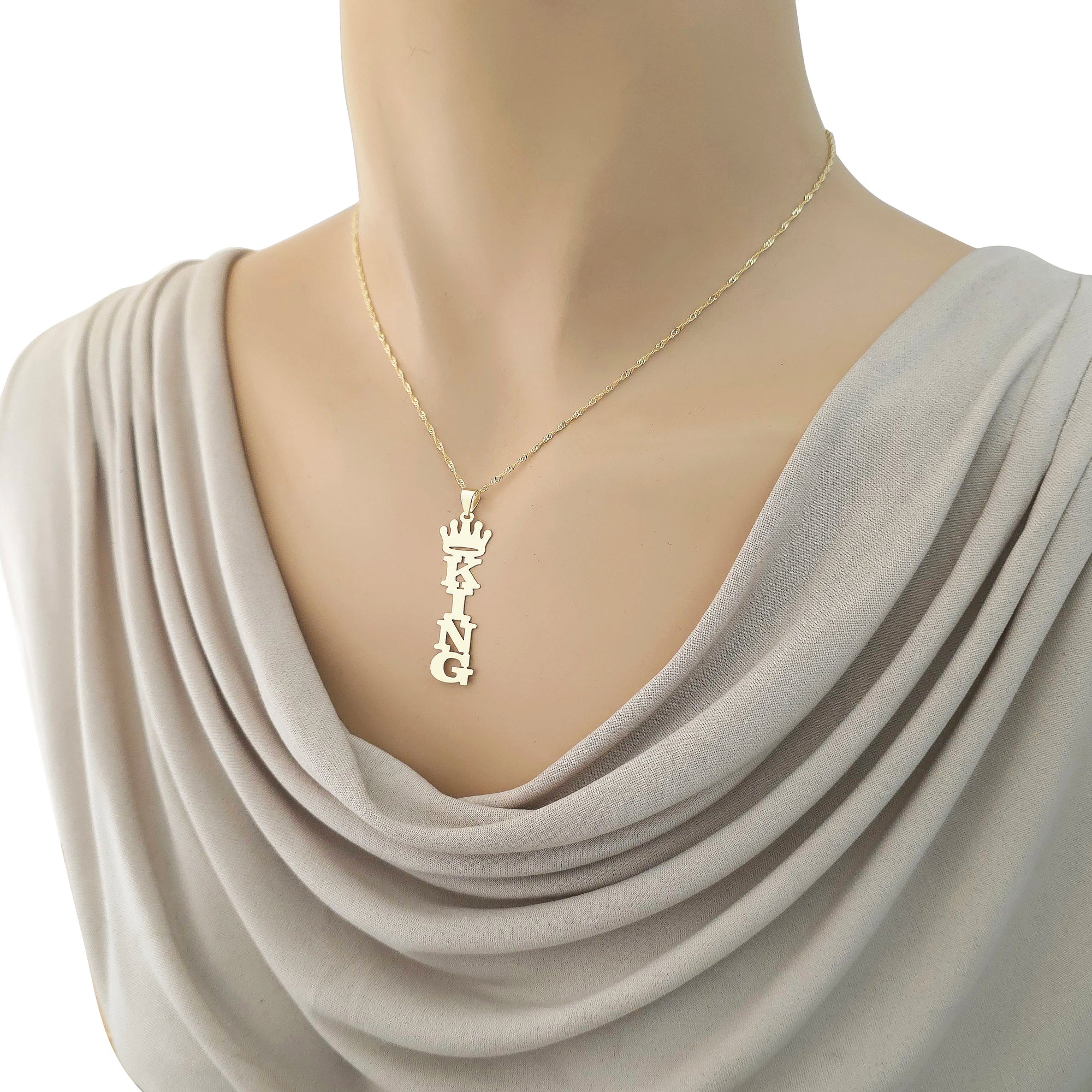 Gold vertical king crown nameplate pendant styled on a 16-inch necklace chain worn on a display mannequin.