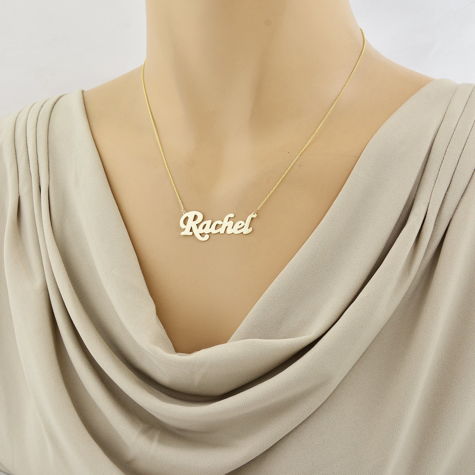 Woman wearing 10k solid gold Rachel script nameplate necklace