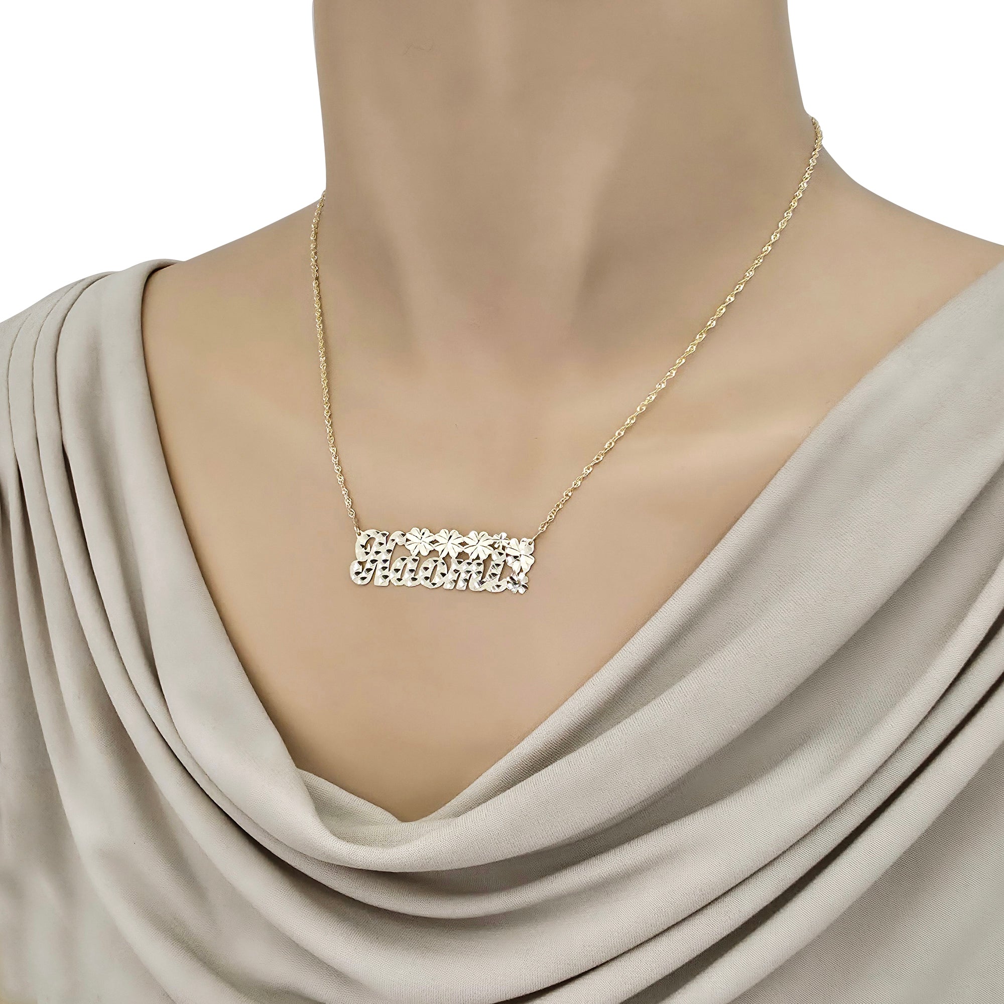 Model wearing a custom 14K gold personalized script nameplate necklace with floral accents.