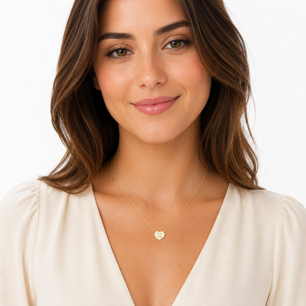 Woman wearing a custom solid gold single initial heart monogram necklace.