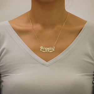 Woman wearing solid gold personalized praying hands cross name necklace