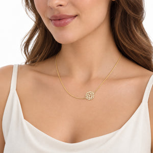 Woman wearing a delicate solid gold three-initial circle monogram necklace