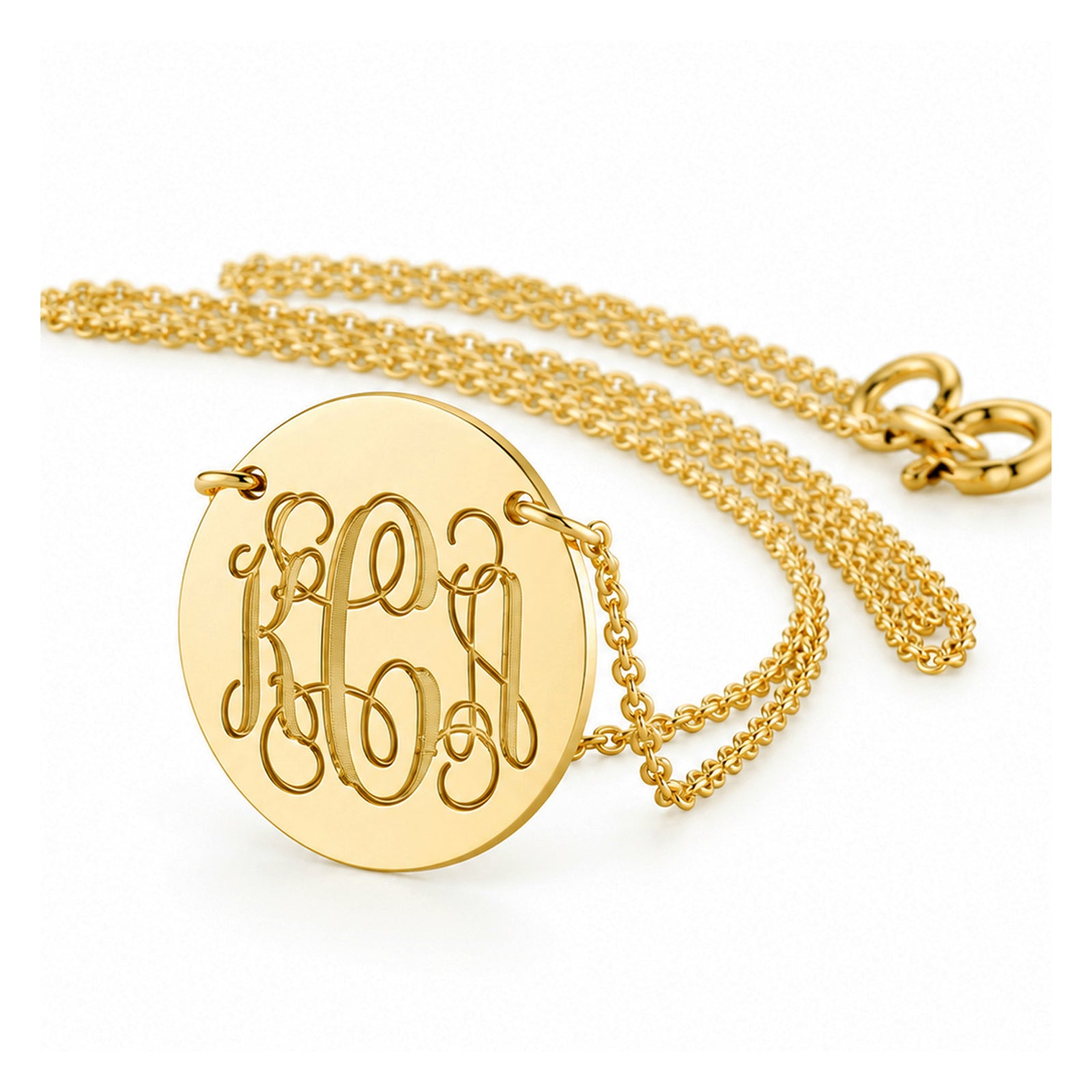 Yellow gold disc necklace with an engraved three-initial script monogram and chain on a white background.