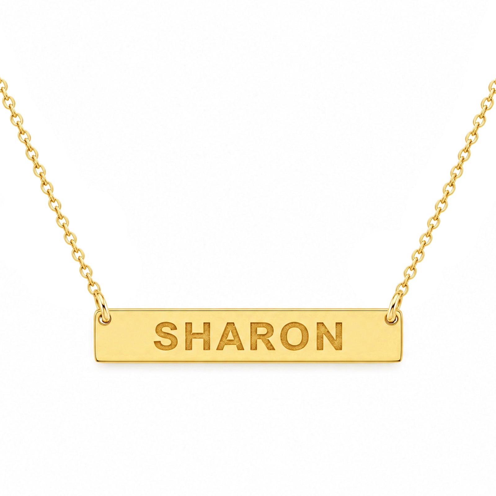 Yellow gold horizontal bar necklace engraved with SHARON on a matching chain against a white background.