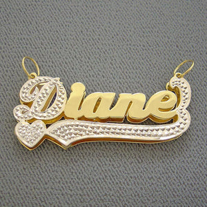 Close-up of 10K solid yellow gold custom 3D name charm showing rhodium white gold diamond-accented tail.