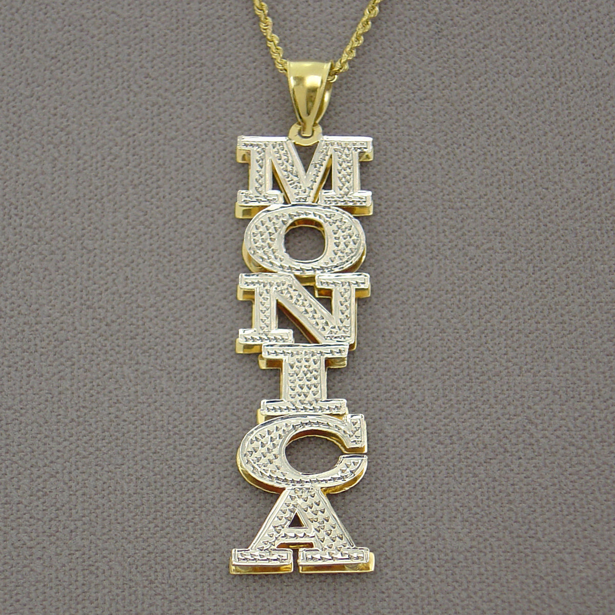 Close-up of two-tone 14K gold 3D double plate personalized name pendant