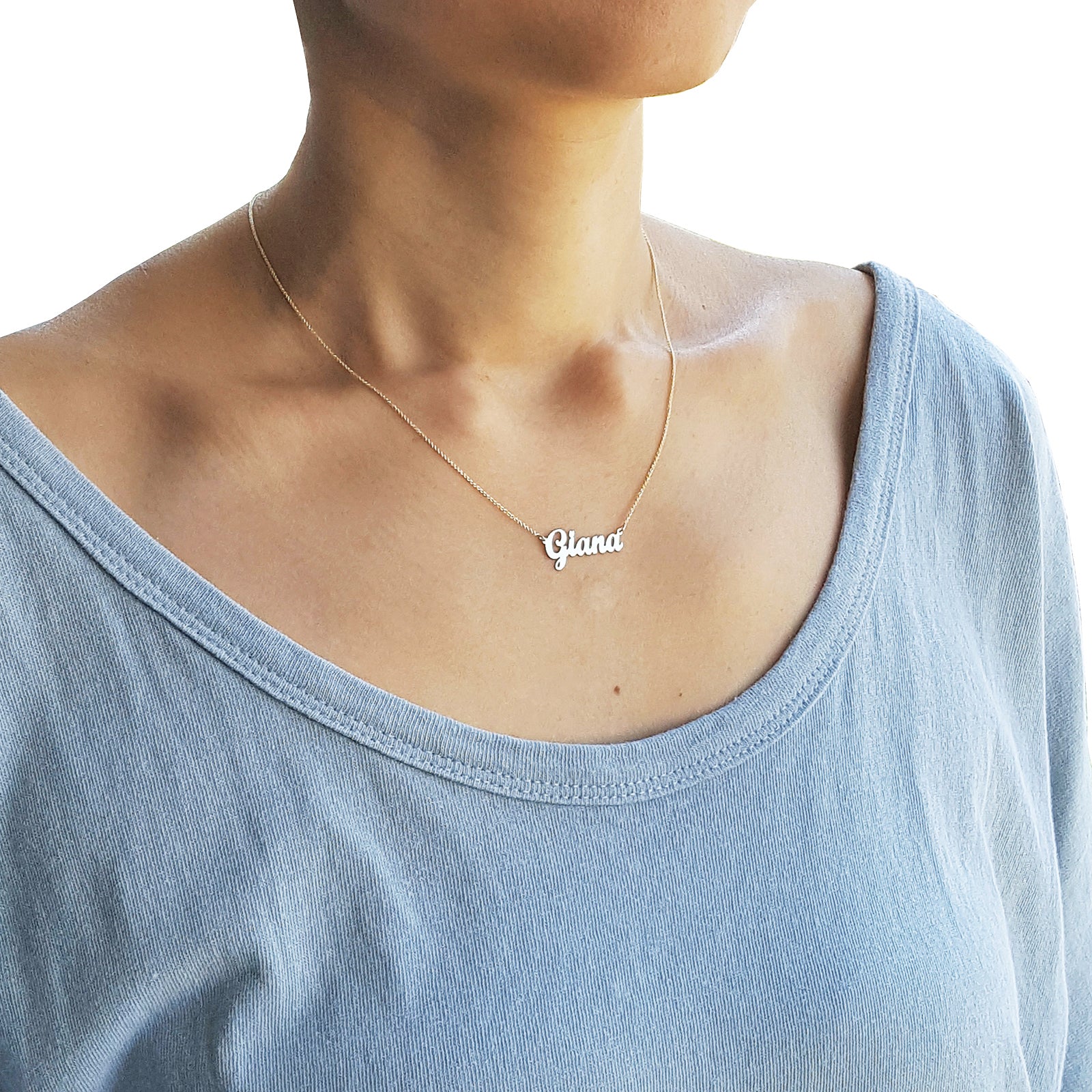 Model wearing 14k solid gold dainty script name necklace on an 16-inch chain.