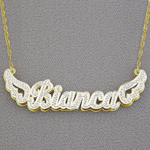 Close-up of the 14k gold hallmark stamp on the back of the custom angel wings name pendant.
