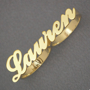 Close-up of handcrafted script cursive lettering on custom solid gold two-finger ring