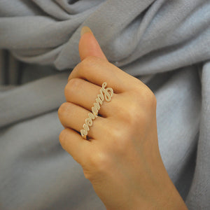 Model wearing custom solid gold Lauren Conrad two-finger name ring across fingers