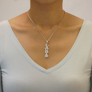 Model wearing a customized sterling silver vertical double name pendant with a rhodium-plated finish.