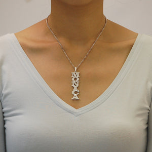 Model wearing personalized sterling silver 3D MONICA vertical name pendant necklace with a rolo chain.