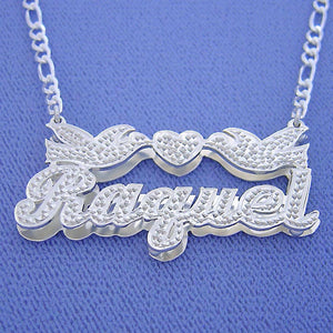 Custom sterling silver "Raquel" 3D name necklace featuring two love birds and a heart, attached to a silver Figaro chain.