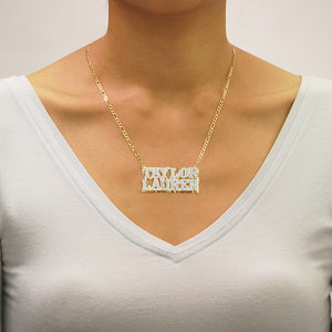 Model showcasing a handcrafted 3D double plate gold couple name pendant.