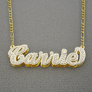 Close-up view of a custom solid gold 3D layered nameplate pendant showing hand-polished edges and white-tone diamond cut accent details.