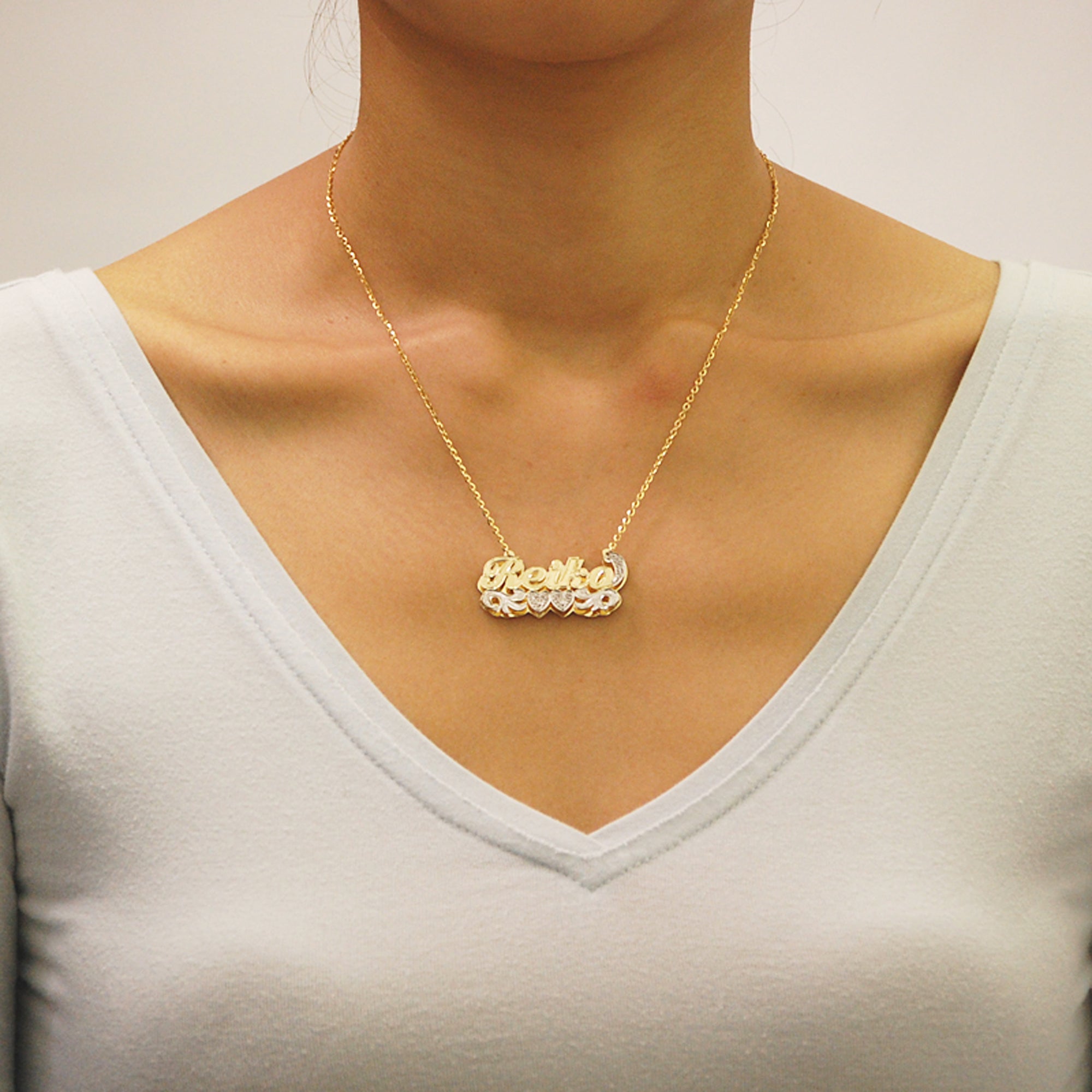Model wearing a personalized 3D double plate gold nameplate necklace with 16-inch chain.