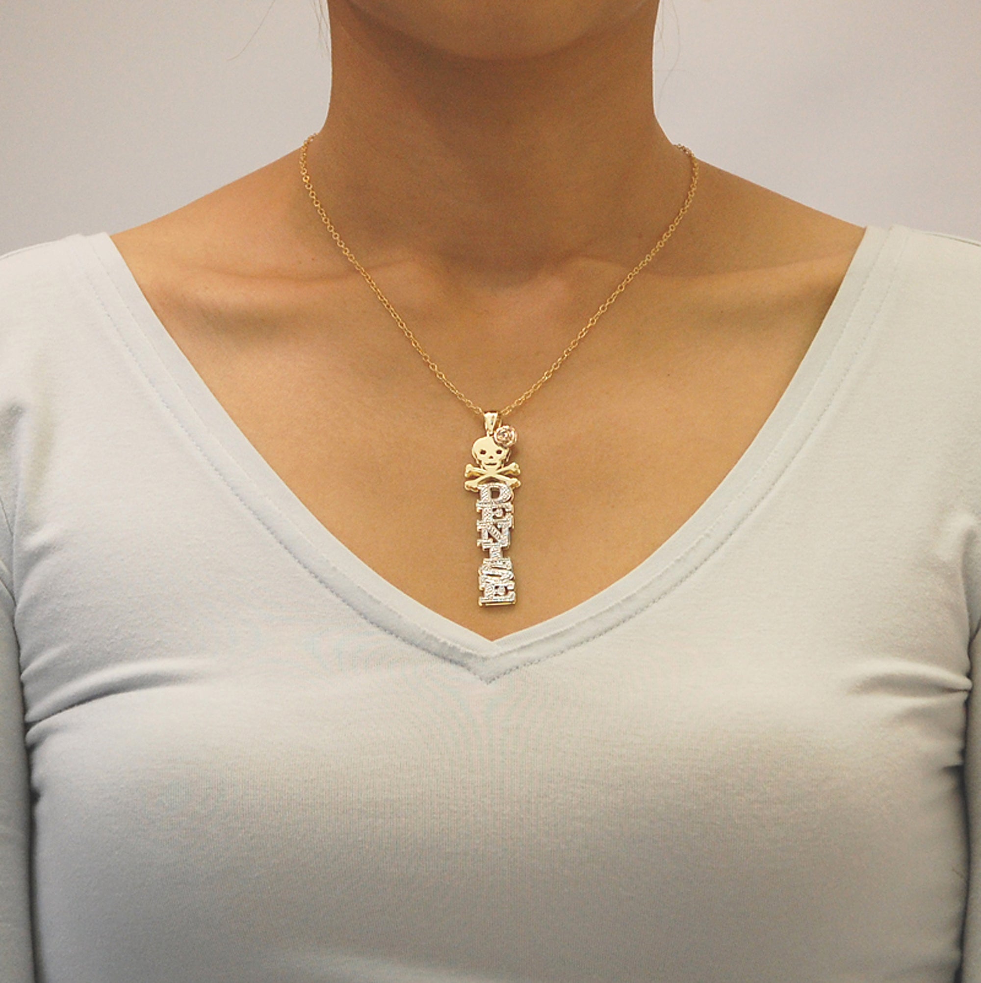 Model wearing the personalized gold 3D vertical skull and rose nameplate pendant layered on a solid gold chain.