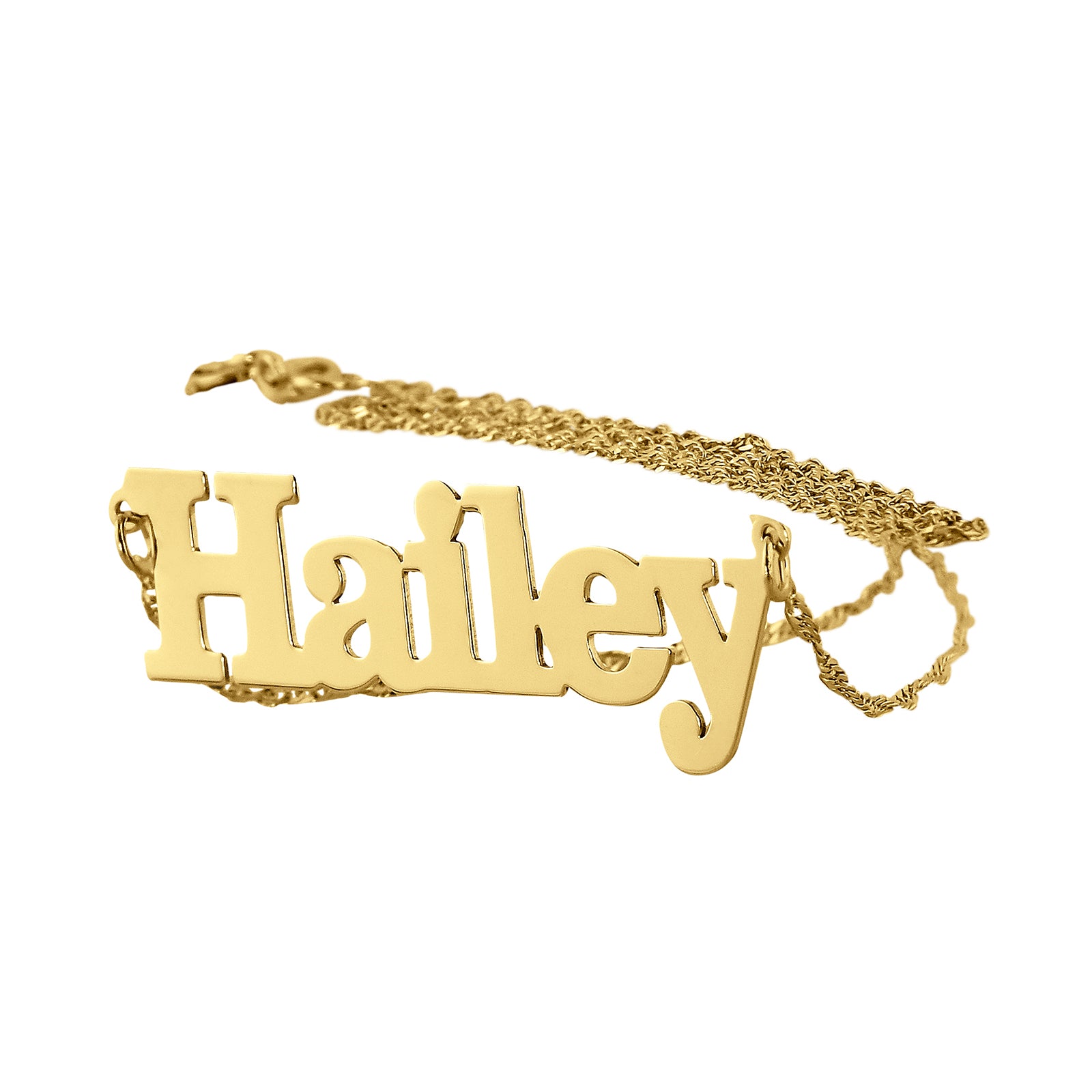 Custom solid gold block font name necklace spelling 'Hailey' with attached chain.