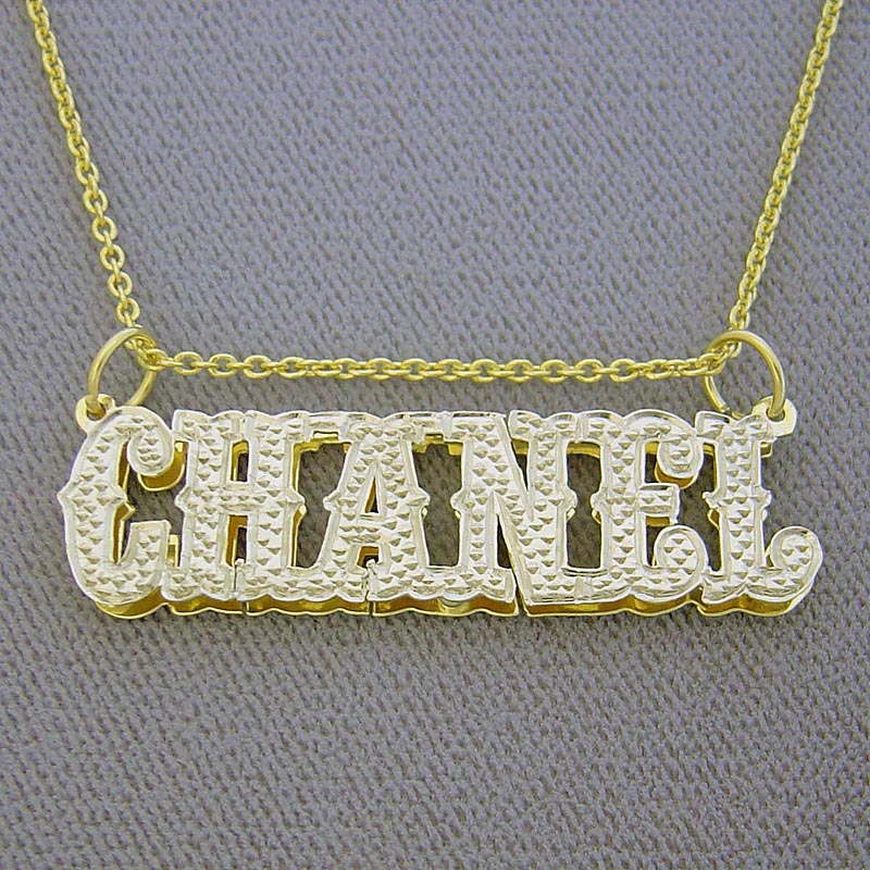 Close-up of custom iced-out gold nameplate pendant in Western cowboy font spelling Chanel.