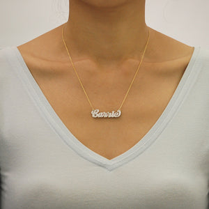 Model wearing a 1.5-inch custom solid gold 3D double plate name pendant on a gold chain.
