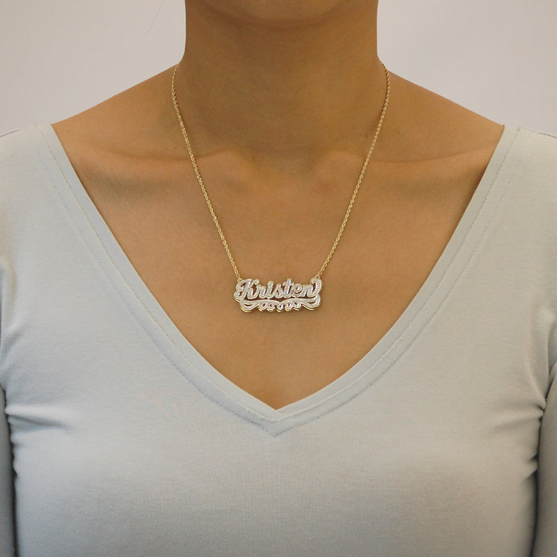 Model wearing personalized 10k solid gold diamond accent name necklace.