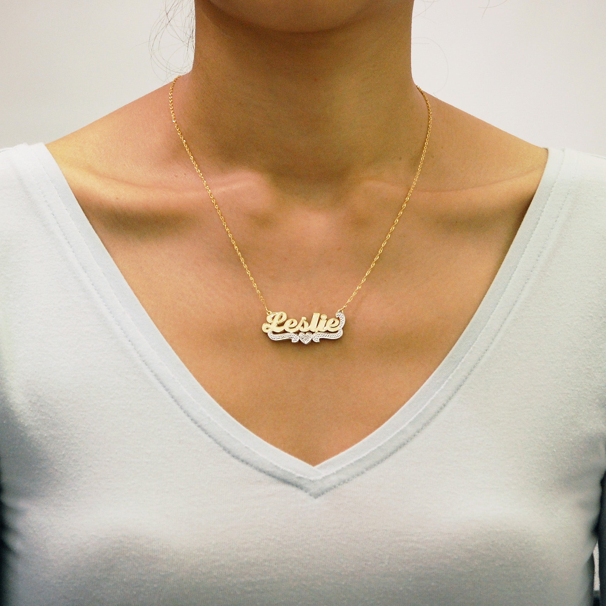 Model wearing junior solid gold custom 3D nameplate necklace with 1.5mm Singapore chain
