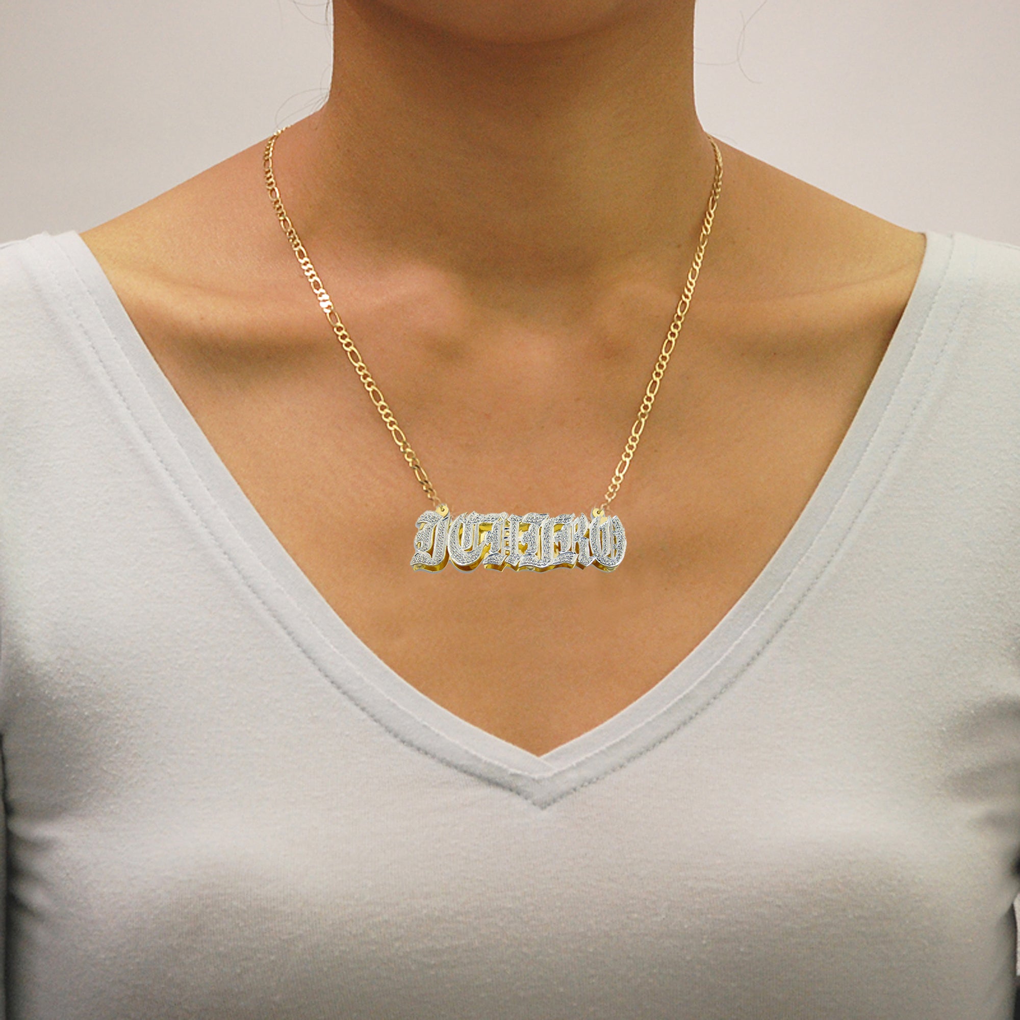Model wearing a personalized 3d double plate diamond nameplate necklace in solid gold.