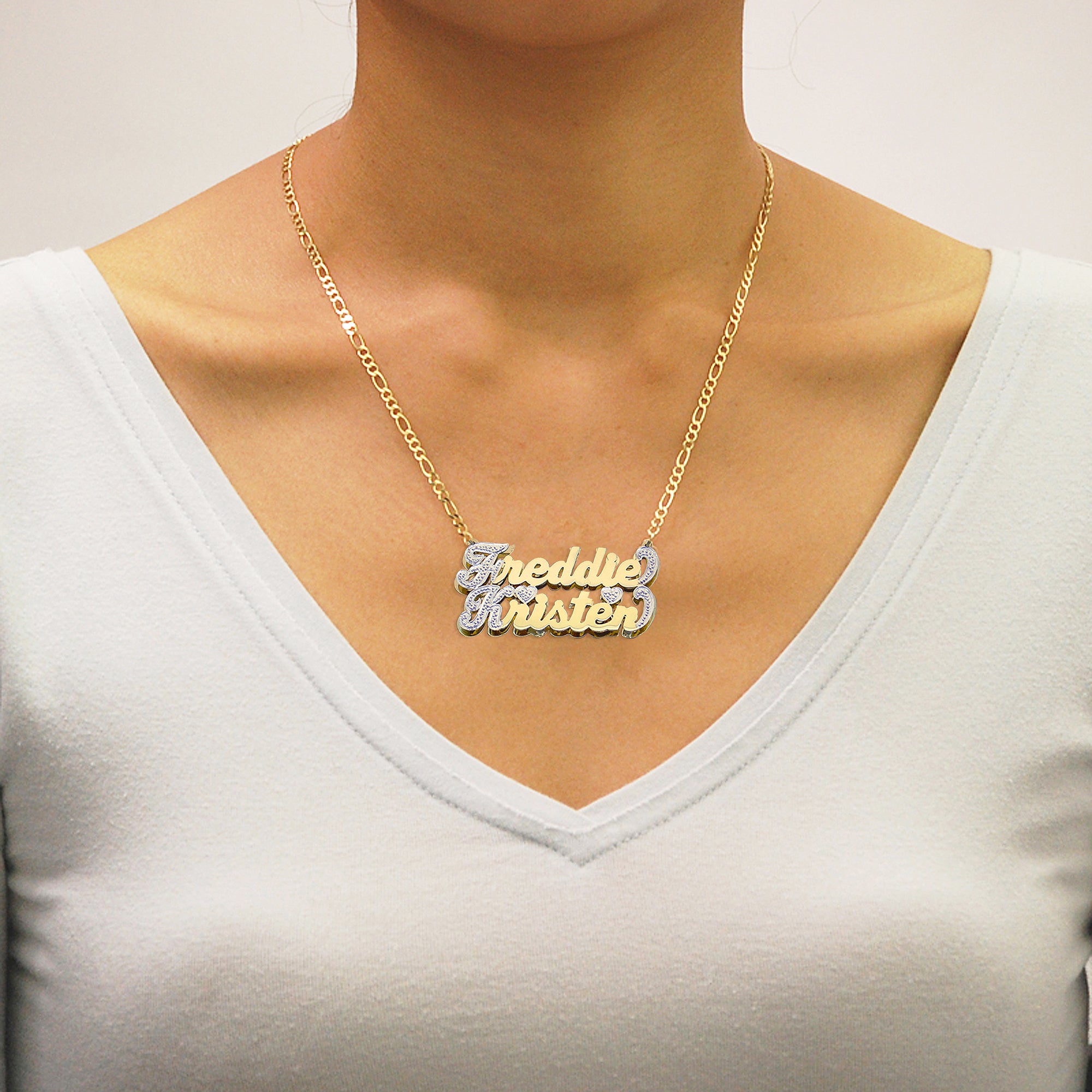 Model wearing the personalized 10K/14K gold double-plate couple name pendant on an 18-inch Figaro chain.