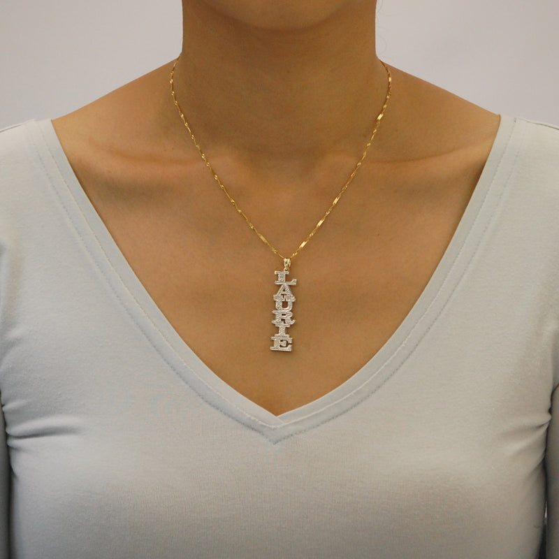 Model wearing custom 3D double plate vertical gold name pendant on a gold chain.