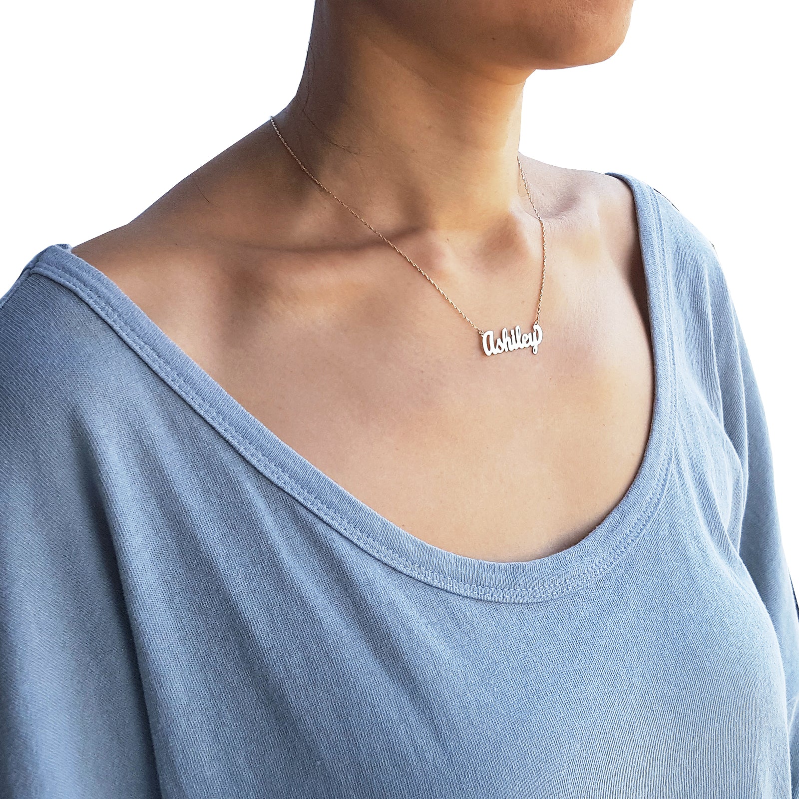 Woman wearing a small 10k solid gold personalized cursive nameplate necklace