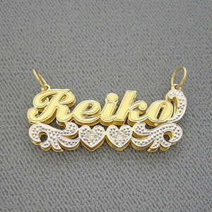 Close-up of solid gold two-tone custom nameplate with white-tone diamond accents.