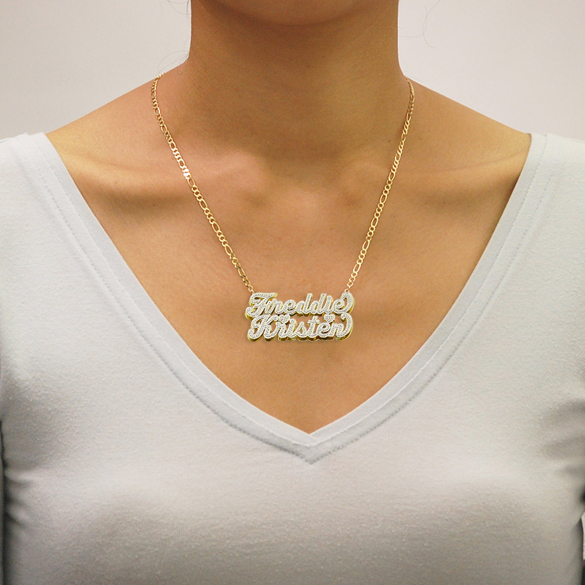 Woman wearing custom 10k gold personalized couple name necklace with two-tone finish