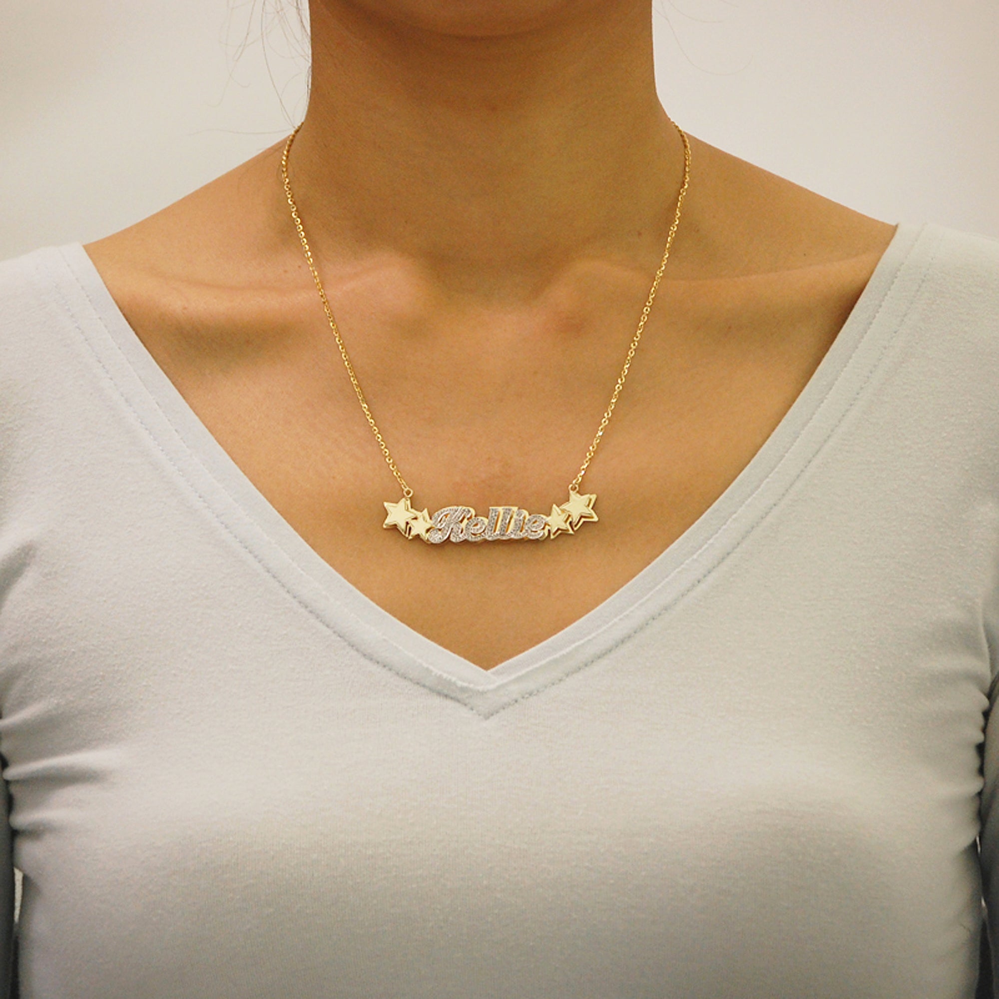 Woman wearing custom 14k solid gold double plate star nameplate pendant necklace handcrafted in Los Angeles.