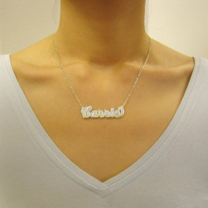 Woman wearing a custom 3D gold double plate nameplate pendant necklace styled on a gold Figaro chain.